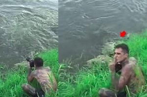 男子專心拍攝鱷魚，就在轉頭跟朋友講話的瞬間，鱷魚已經游到身邊...